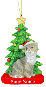 Ornaments shaped like a cat in front of a tree. One ornament features a black and white cat. One ornament features an orange and white cat. One ornament features a light gray and dark gray cat. One ornament features a white cat. All the cats are wearing Santa hats.
