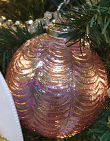 This image shows the ornament hanging in a green Christmas tree.