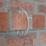 This is a lifestyle image showing the clear light clip being used on a brick.