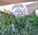 This is a lifestyle image showing a wreath hanging from the hook/suction cup.