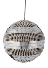 Round ornament decorated with shiny mosaic tiles and pearl accents.