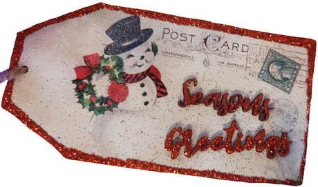 Decorative Christmas tag with snowman and 'Season's Greetings' text on a white background