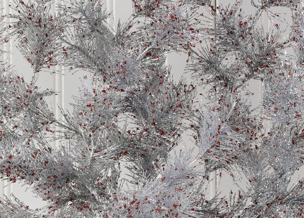 Silver pine spray with red flecks.