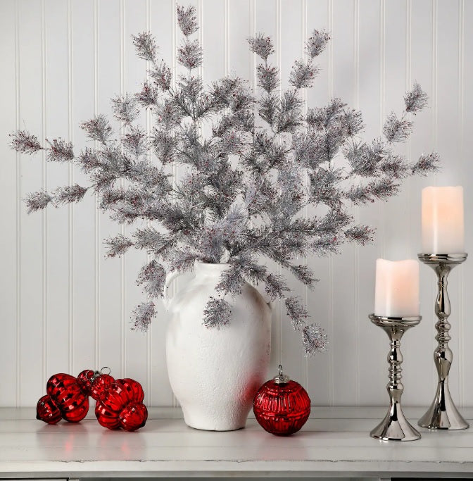 Silver pine spray with red flecks.