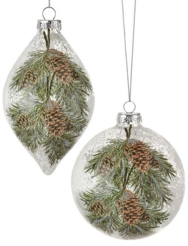 Glass ornament featuring pine cones and pine needles. Each ornament is decorated to appear covered in frost. One is finial-shaped and the other is bauble-shaped.