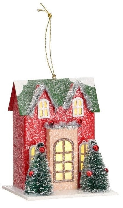 Christmas ornament shaped like a house. Colors are red, green, tan and white.