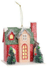 Christmas ornament shaped like a house. Colors are red, green, tan and white.