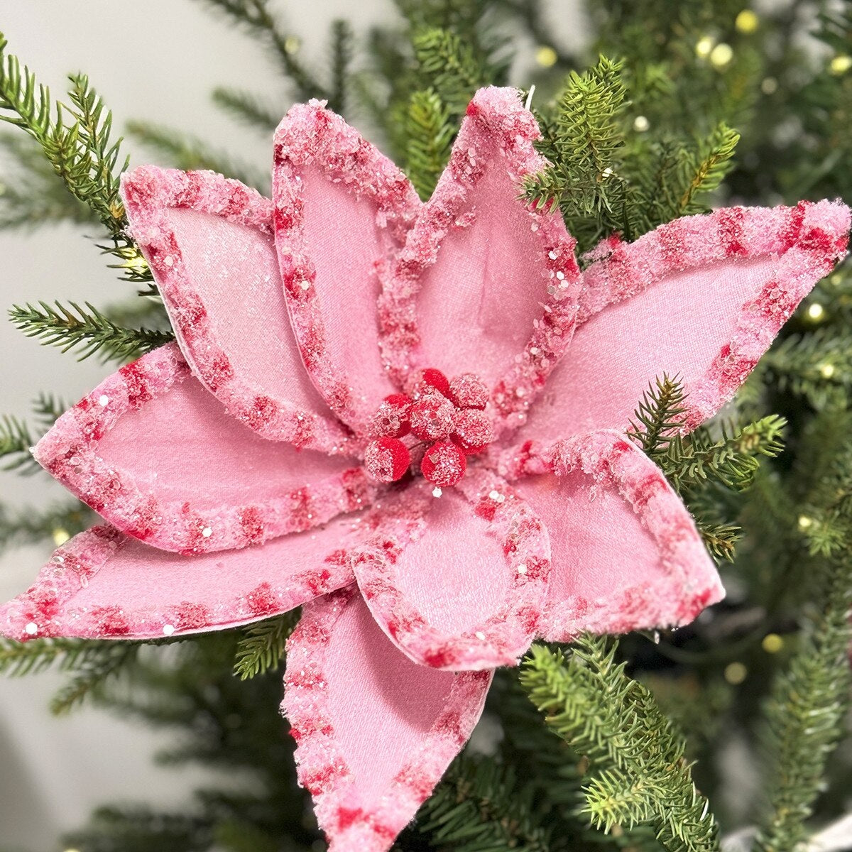 Pick spray designed to look like a poinsettia made out of pink and red candy.