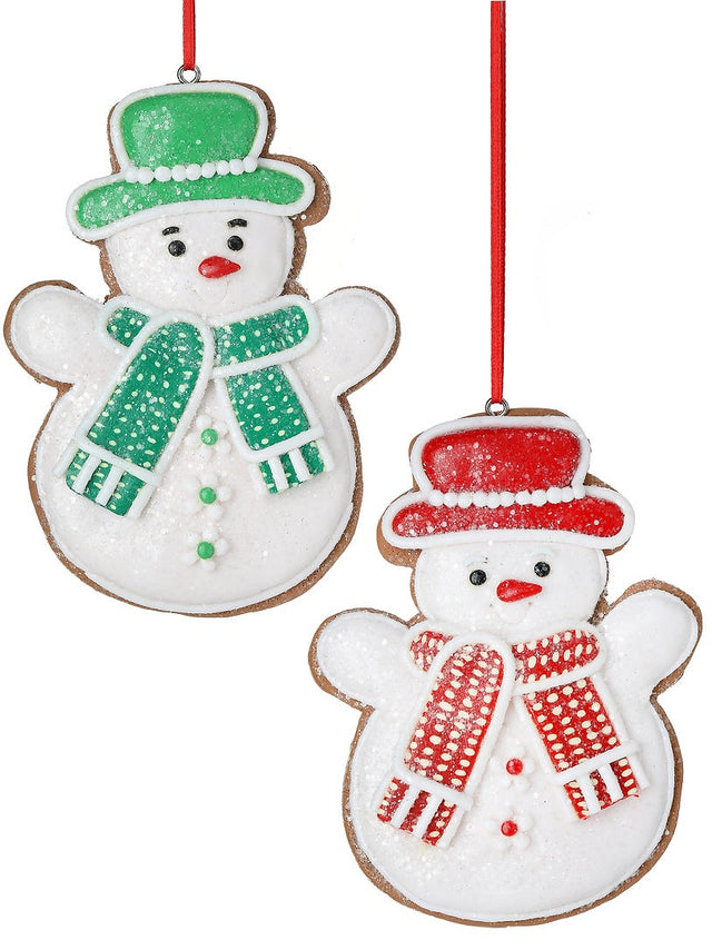 Christmas ornament designed to look like a gingerbread cookie shaped like a snowman. One snowman is wearing a green top hat and a green scarf. One snowman is wearing a red top hat and a red scarf.