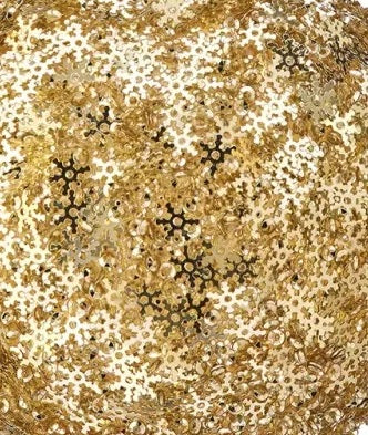 Ball ornament covered in gold snowflake shaped sequins.
