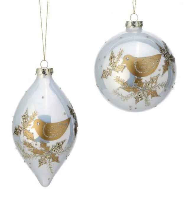 Made of glass, glitter and gemstones. One ornament is bauble shaped. One ornament is finial shaped. Both ornaments feature a gold dove with gold holly leaves.