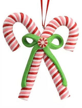 An ornament shaped like two red, white and pink candy canes tied together with a green bow.