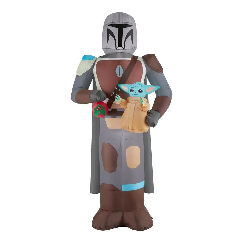 Christmas inflatable designed to look like the Star Wars characters The Mandalorian and Grogu. Mando is holding Grogu and a red holiday ornament.