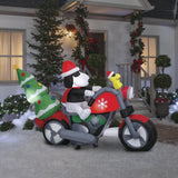 Christmas inflatable. It features Snoopy wearing a Santa hat and wearing sunglasses. Snoopy is driving a red motorcycle with a snowflake accent on it. There's a decorated Christmas tree on the back and Woodstock is riding on the handlebars. There are LED lights inside.