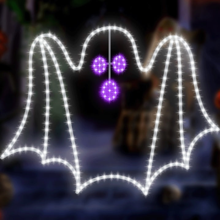 LED decoration shaped like a white ghost with bright, purple eyes and mouth.