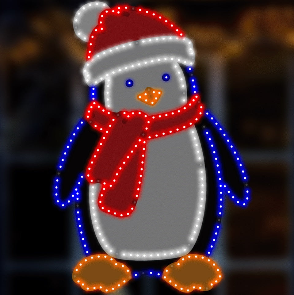 Outdoor LED decoration shaped like a penguin wearing a Santa hat and red scarf. The lights are red, pure white, blue and orange.