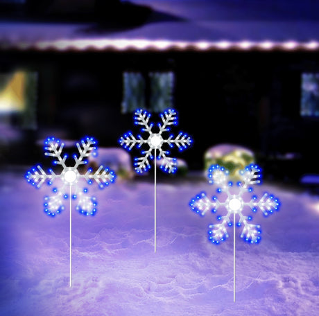 Outdoor LED decoration shaped like a snowflake. It's lit with blue and pure white lights.