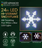 Outdoor LED decoration shaped like a snowflake. It's lit with blue and pure white lights.