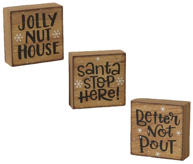 Square shaped holiday sign. One sign reads "Jolly Nut House." One sign reads "Santa Stop Here!" One sign reads "Better Not Pout."