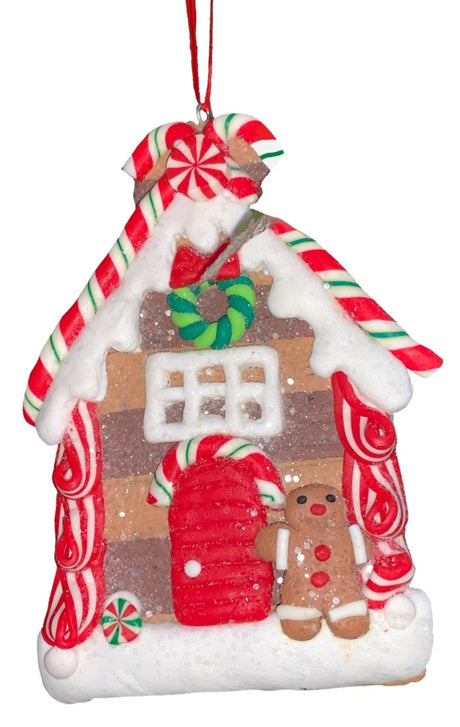 This ornament was designed to look like a gingerbread cookie house covered in sugar. This specific ornament has long red, green and white candy canes on the roof and features a gingerbread man on the right side of the front door.