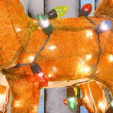 This is an up close image showing the brown fabric of sculpture, as well as the multi-colored light bulbs on the light string.