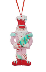 This ornament features a toy soldier wearing a pink outfit, a red hat and he's holding a small tree with a peppermint trunk.