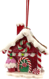 Ornaments shaped like gingerbread houses decorated with sugar, frosting, peppermint candies, gummy candies and candy canes. This one is accented with a cupcake and a peppermint candy.