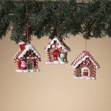 Ornaments shaped like gingerbread houses decorated with sugar, frosting, peppermint candies, gummy candies and candy canes.