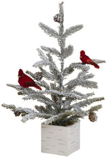 Tabletop tree in a birch planter box. The branches of the tree are dusted with white to mimic snow. The tree is accented with two red cardinal birds and some snow-covered pine cones.