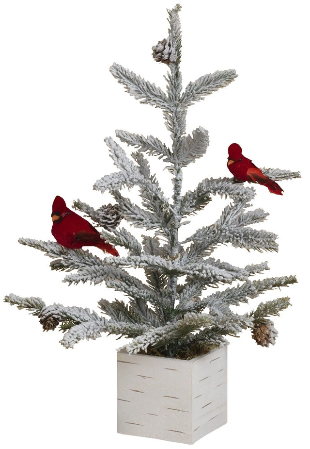 Tabletop tree in a birch planter box. The branches of the tree are dusted with white to mimic snow. The tree is accented with two red cardinal birds and some snow-covered pine cones.