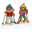 Resin figurine for a Lemax display. Designed to look like two gingerbread people walking in the snow with snow shoes on. They're decorated to look like they're wearing winter clothes.