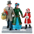Resin figurine for a Lemax Village display. Designed to look like a mom, a dad and a young girl dressed in winter clothes. The dad is carrying a basket of presents. The ground looks like stone and features two piles of snow.