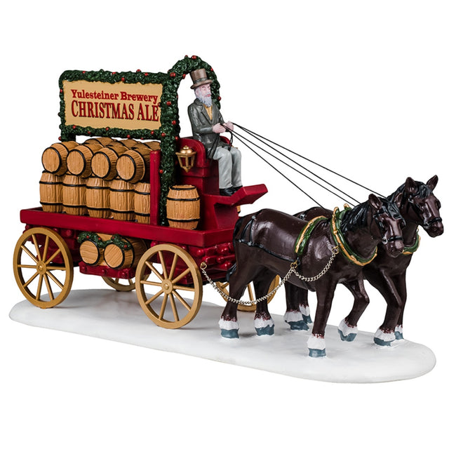 Resin figure for a Lemax Village display. Designed to look like two horses pulling a wagon full of barrels of ale. The wagon is decorated with garland. The man holding the reins for the horses is wearing a suit and top hat and has a long white beard. The ground has snow on it.
