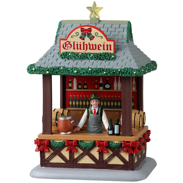Resin table accentstar on the roof and garland on the edges of the  for a Lemax display. Designed to look like a wooden booth with a stone roof. There's a star on the roof and garland around the edges of the roof. The sign reads "Glühwein." There's a smiling vendor behind the bar of the booth wearing a green top hat. The wall behind the vendor features a bunch of different bottles and there are barrels of alcohol. There's a garland around the bottom of the booth's bar and features a bunch of red bows.