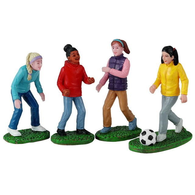 Resin figurines for a Lemax Village tabletop display. Designed to look like four girls playing soccer. They're all wearing long sleeve shirts and pants.