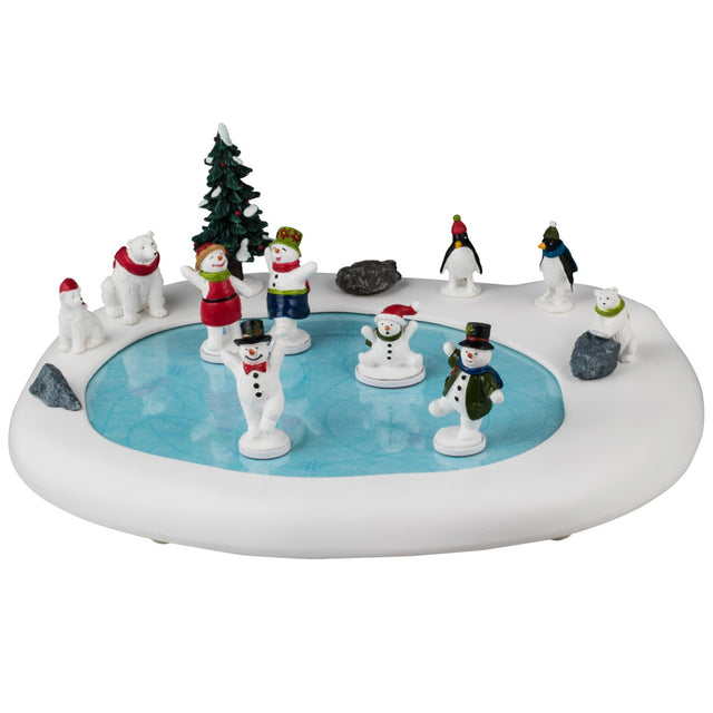 Animated resin table accent for a Lemax display. Designed to look like a frozen pond surrounded by snow and a few rocks. There are five snow people skating on the ice, all wearing winter clothes. There are three polar bears and two penguins watching. The animals are all wearing either a winter hat or a scarf.