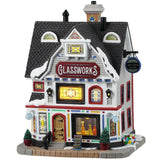 Porcelain lighted building for a Lemax display. Designed to look like a large, white house that's been turned into a shop. There's snow on the roof and most of the windows are stained glass. If you look in the window next to the door, you can see some glass vases.