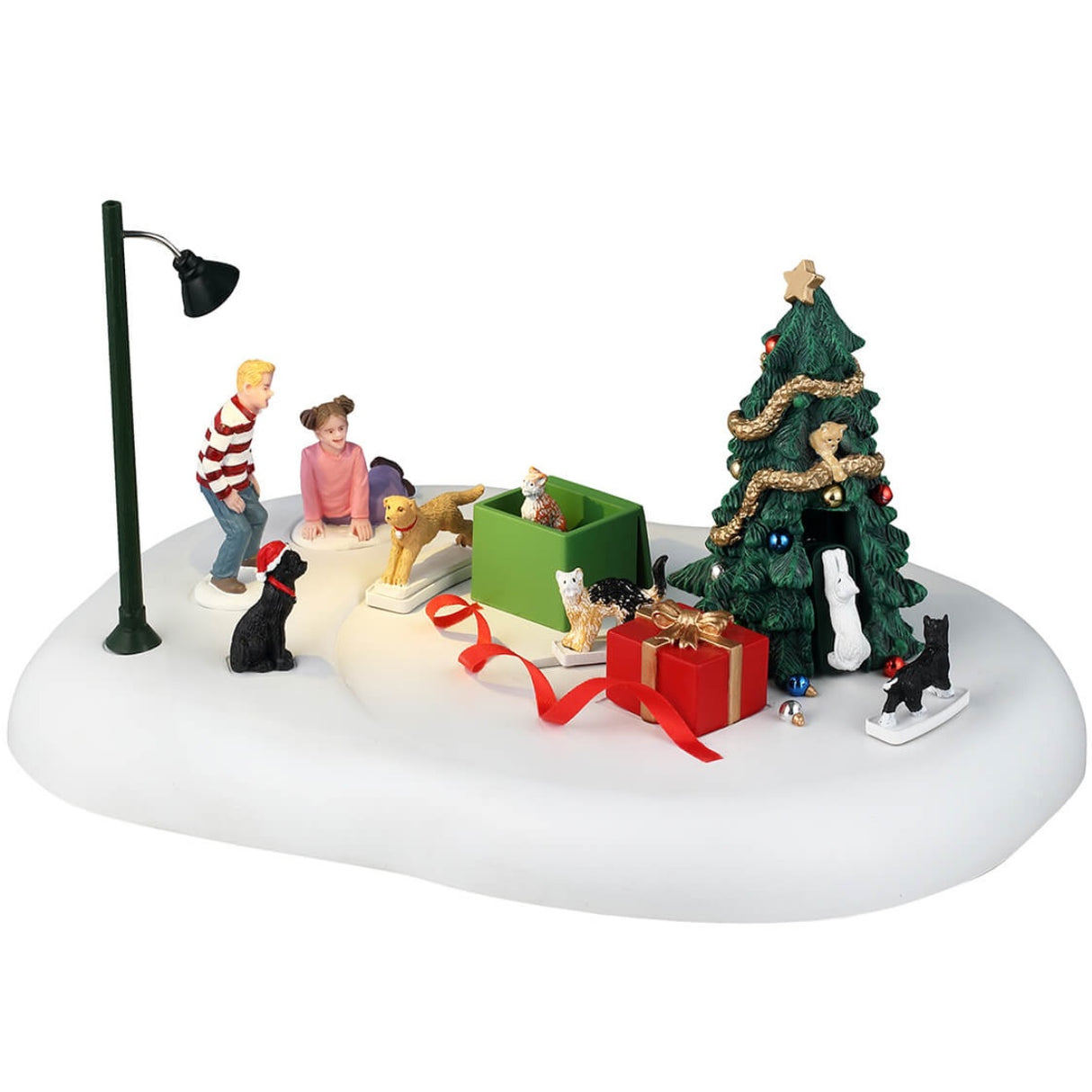 Resin table accent for a Lemax display. Designed to look like a snowy patch with a few kids unwrapping presents. Inside one of the boxes was a yellow cat, a black cat wearing a Santa hat, a multi-colored cat, another black cat and a white cat. There's also a decorated Christmas tree nearby and a lamppost.