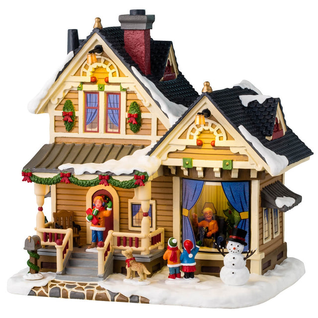 Resin lighted building for a Lemax display. Designed to look like a charming house covered in snow and decorated with wreaths and garlands. There are two children who just made a snowman and are now waving at Grandma in the window.