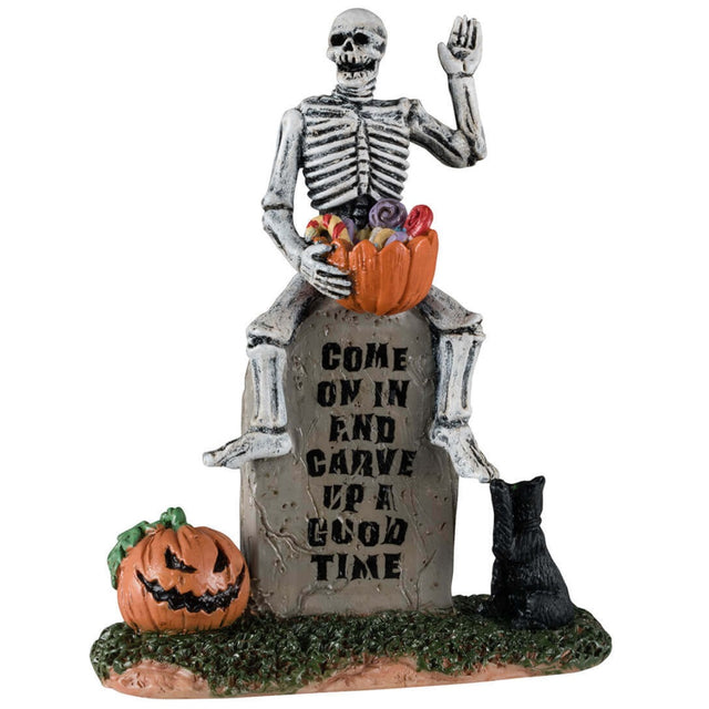 Resin figurine for a Lemax display. Designed to look like a skeleton handing out candy while sitting on a tombstone. The tombstone reads "Come on in and carve up a good time." There's a carved jack-o-lantern and a black cat next to him.
