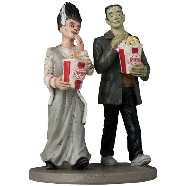 Resin figurine for a Lemax display. Designed to look like Frankenstein and the bride of Frankenstein walking and eating popcorn.