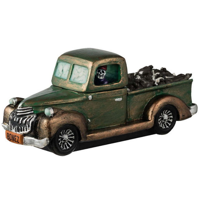 Resin figurine for a Lemax display. Designed to look like a rusty, green truck driven by a skeleton. There's a lot of garbage in the truck bed. The license plate is orange and reads "BONEZ."