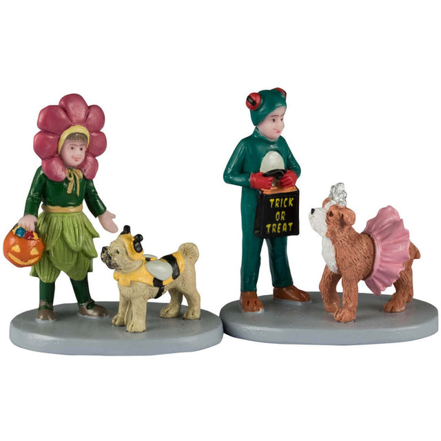 Resin figurine for a Lemax display. Designed to look like two trick or treaters. One is dressed as a flower and she's pointing at her dog who is dressed like a bumblebee. The other trick or treater is dressed as a frog and his dog is dressed like a ballerina.