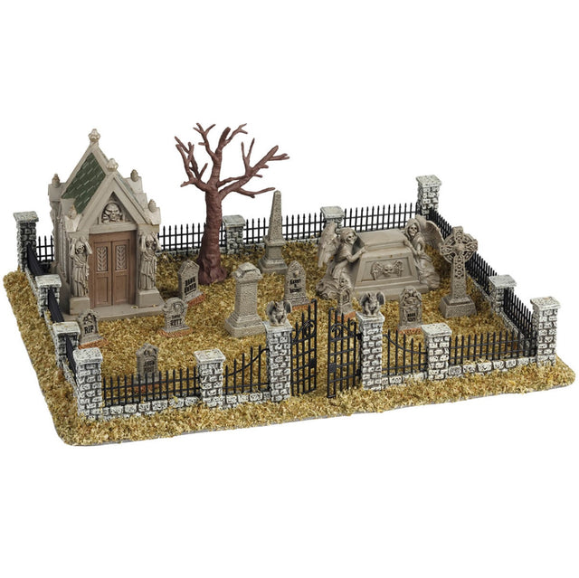Resin village accent for a Lemax display. Designed to look like a graveyard full of dead grass. There are tombstones and headstones and mausoleums. There's also a bare tree and a metal fence with stone columns. 