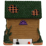 Resin building for a Lemax display. Designed to look like a rundown house. Part of the roof is missing and the windows are boarded up. There's a woman wearing a light blue dress in the doorway handing out candy. There's a black cat and two carved pumpkins and a tombstone that reads RIP.