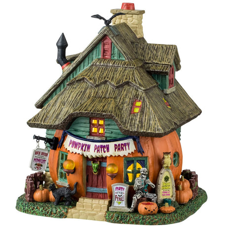 Porcelain lighted building for a Lemax display. Designed to look like a cabin made out of a pumpkin. There's a skeleton sitting in front of the house and a black cat and jack-o-lantern accents. There's a sign above the front door that reads "PUMPKIN PATCH PARTY."