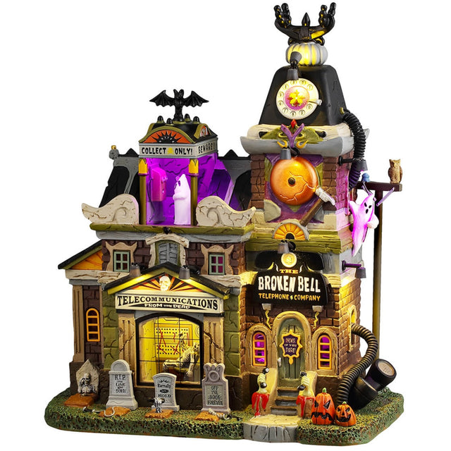 Resin lighted building for a Lemax display. Designed to look like a spooky mansion turned into a telephone company. There are tombstones and jack-o-lanterns in front and ghosts near the roof. It's a little rundown and there are purple lighted accents.
