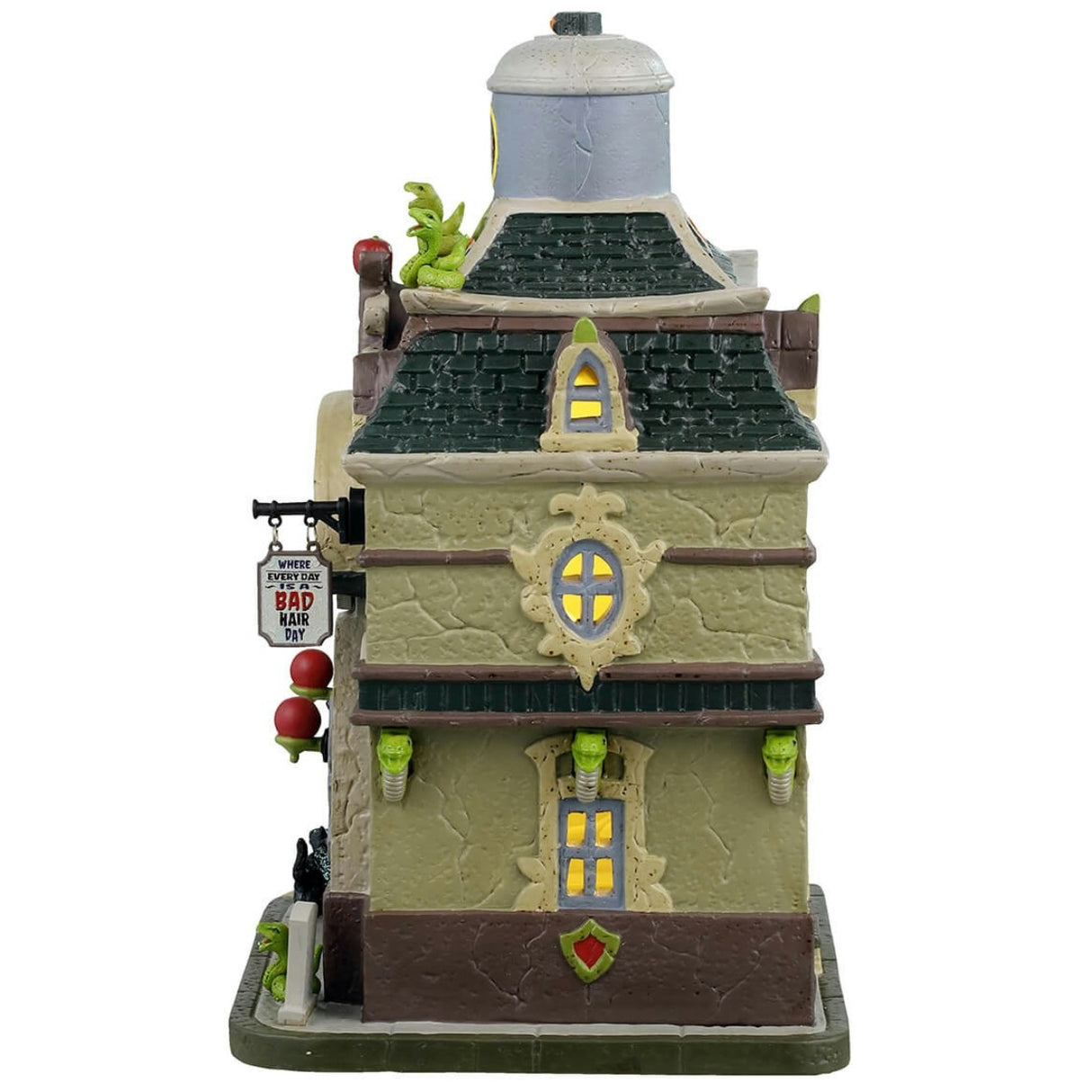 Porcelain lighted building for a Lemax display. Designed to look like a magic shop. There are snake accents and lights shaped like apples. Inside the window you can see a skeleton and a witch shopping.