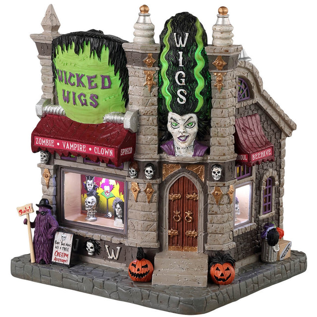Resin lighted building for a Lemax display. Designed to look like a gothic wig store. The sign reads "WICKED WIGS" and looks like the top of Frankenstein's head. There's also a statue of the Bride of Frankenstein. There are skulls and pumpkins and cousin IT standing outside. They sell zombie wigs, vampire wigs, clown wigs and more.