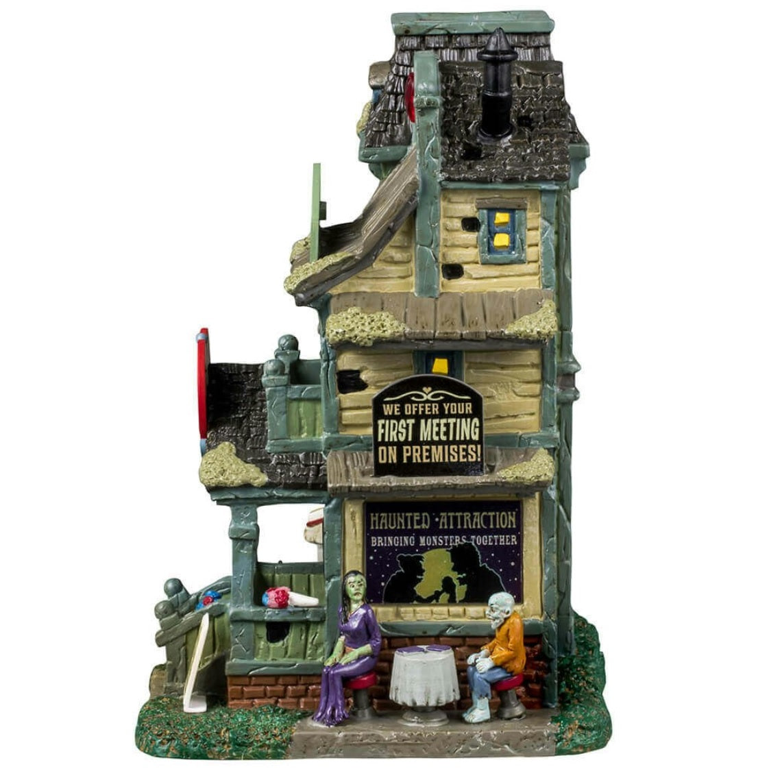 Porcelain lighted building for a Lemax display. Designed to look like light green three story building with moss growing on the roof. The top sign reads "OVER 200 CLIENTS! FROM GNOMES TO GIANTS!" The sign above the front door is shaped like a heart and reads "HAUNTED ATTRACTION. MONSTER MATCHMAKING AGENCY." There are two monsters on a date on the side of the building.